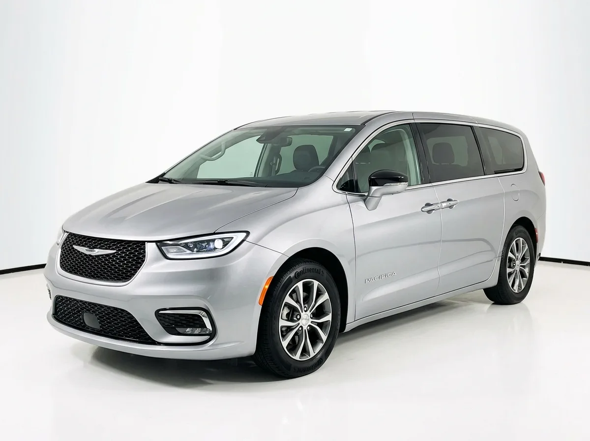 Chrysler Pacifica minivan, silver, front three-quarter view on white studio background, clean product shot